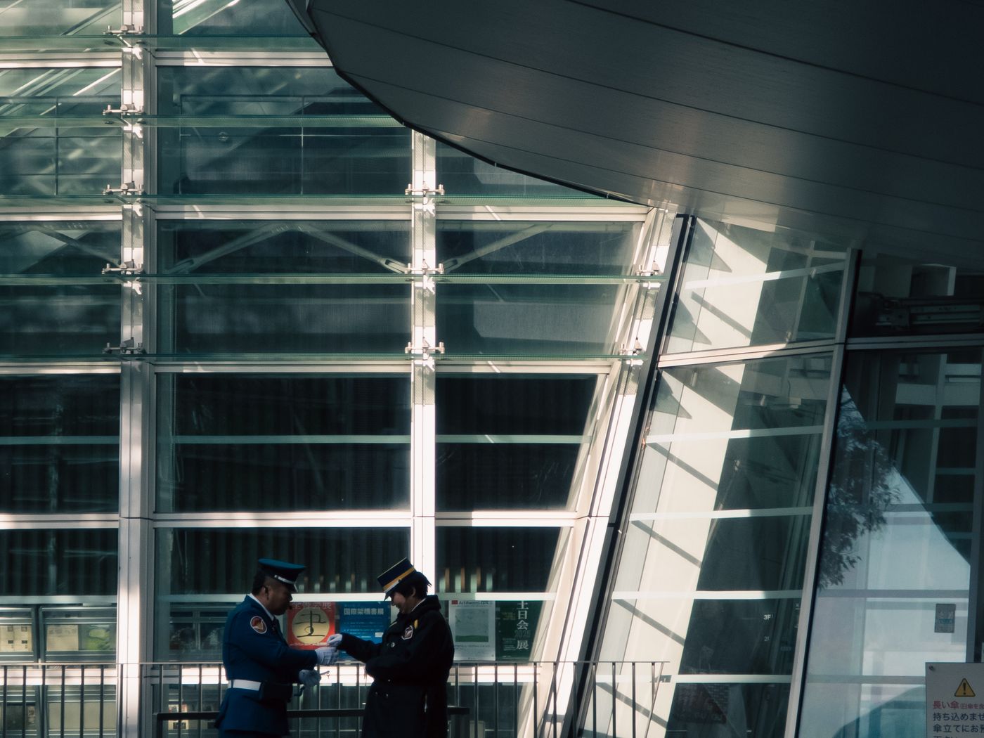 Two security officers reviewing paperwork during a walk-through of a site